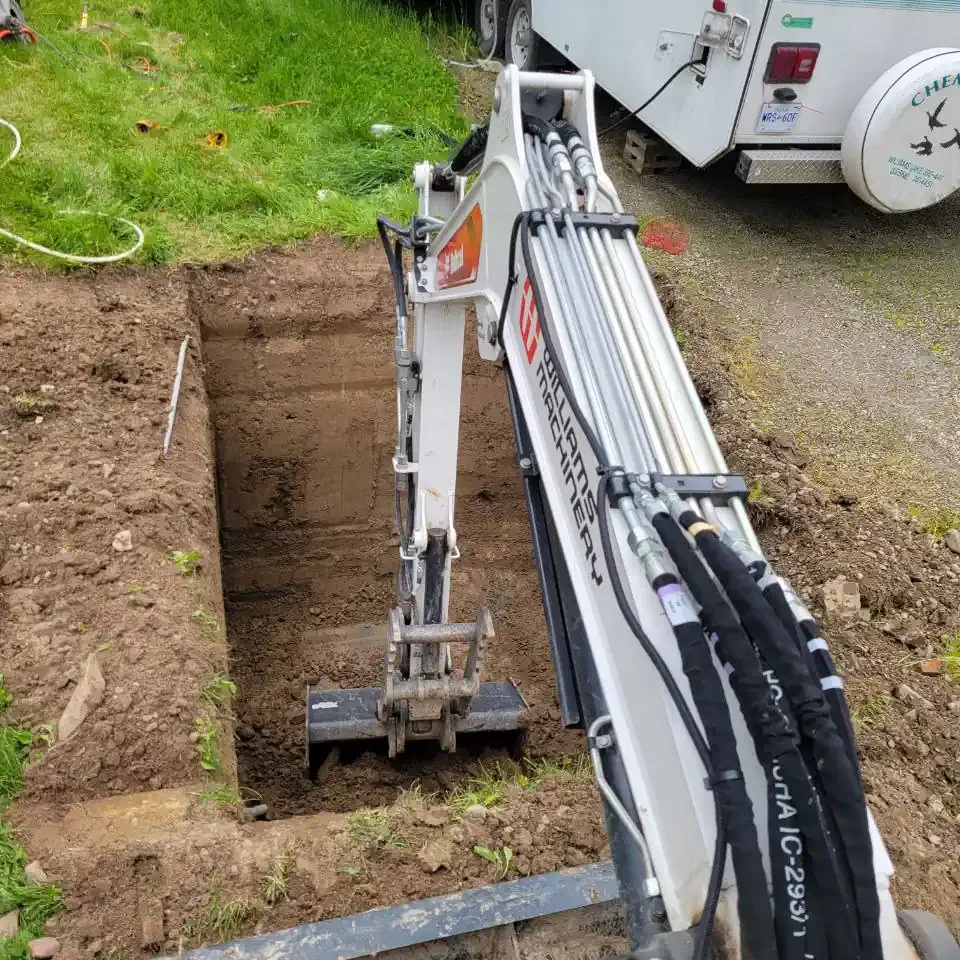 Excavator Work Bobcat mini excavator digging a trench